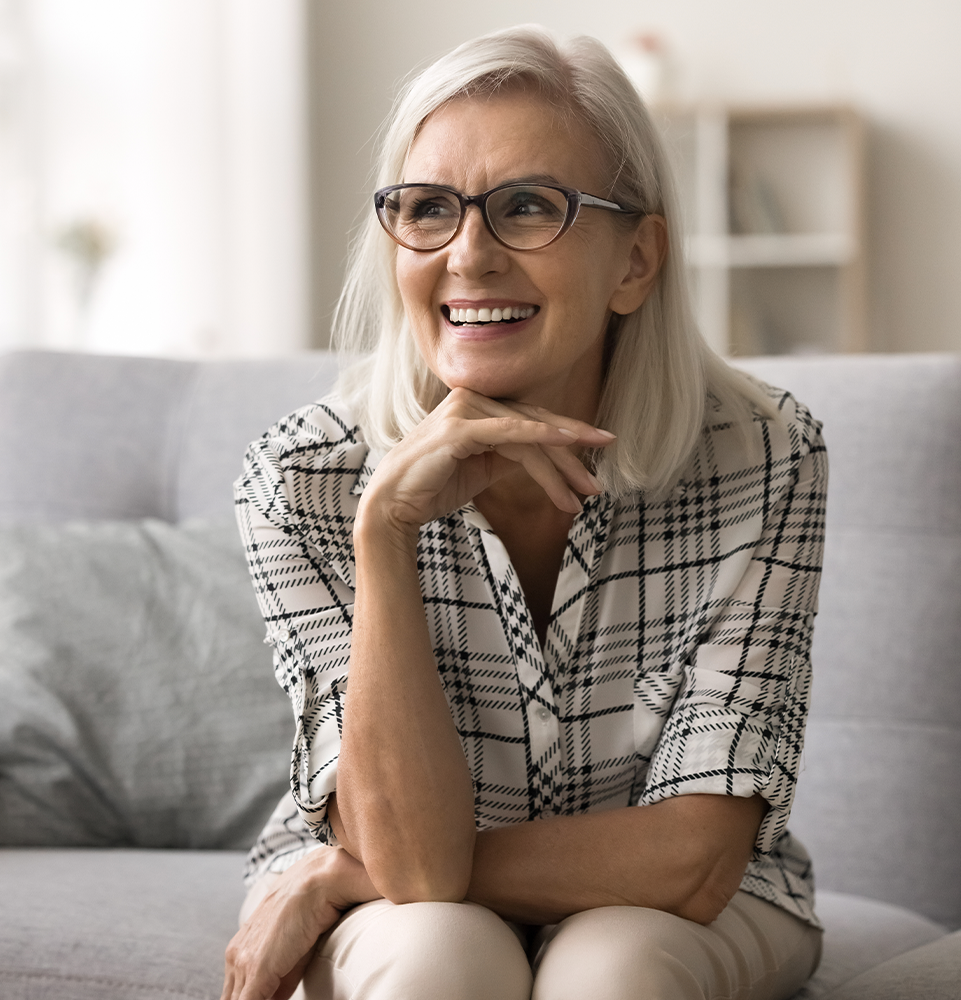 older woman smiling on couch