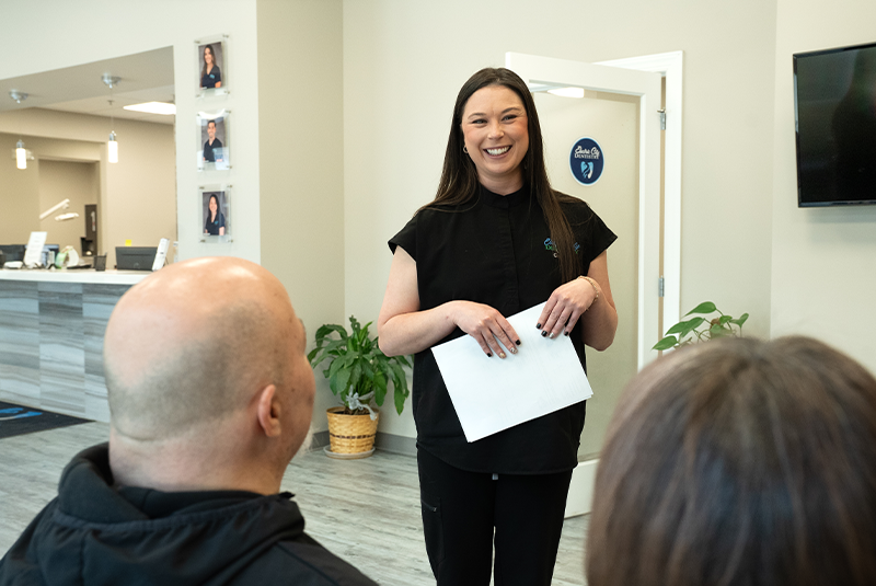staff member talking with patients in the lobby